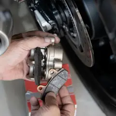 Mani che sostituiscono pastiglie freni posteriori moto. Valutazione della durata pastiglie freni posteriori.