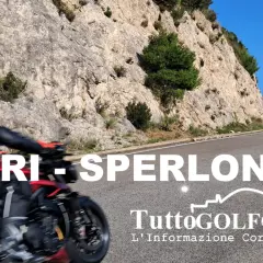 Motociclista in corsa su una strada panoramica tra Itri e Sperlonga, con rocce scoscese e cielo azzurro.