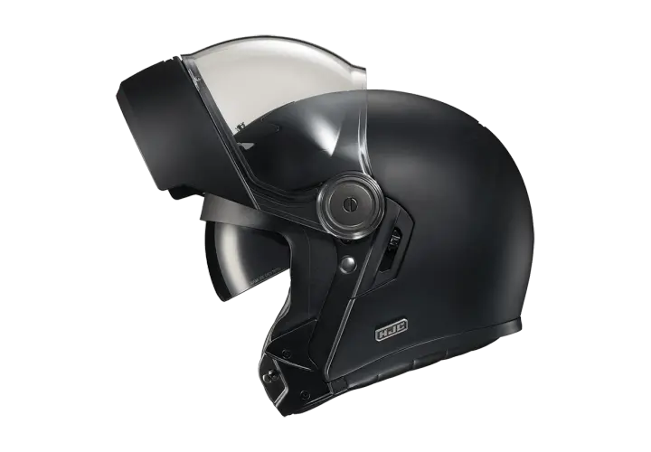 Casco nero con visiera sollevata, pronto per un viaggio senza mal di testa.