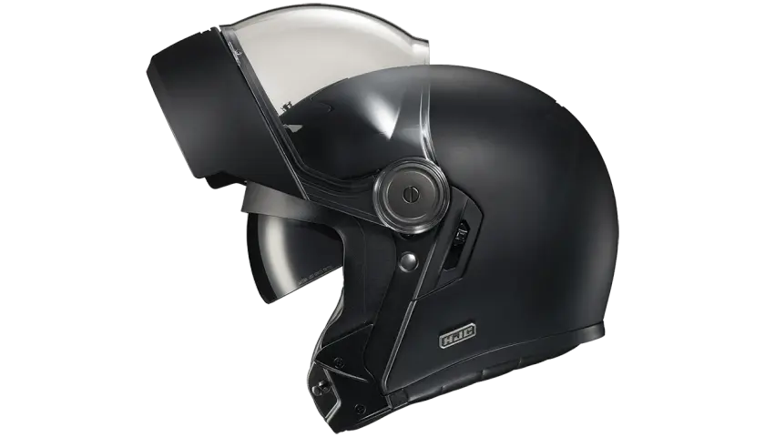 Casco nero con visiera sollevata, pronto per un viaggio senza mal di testa.