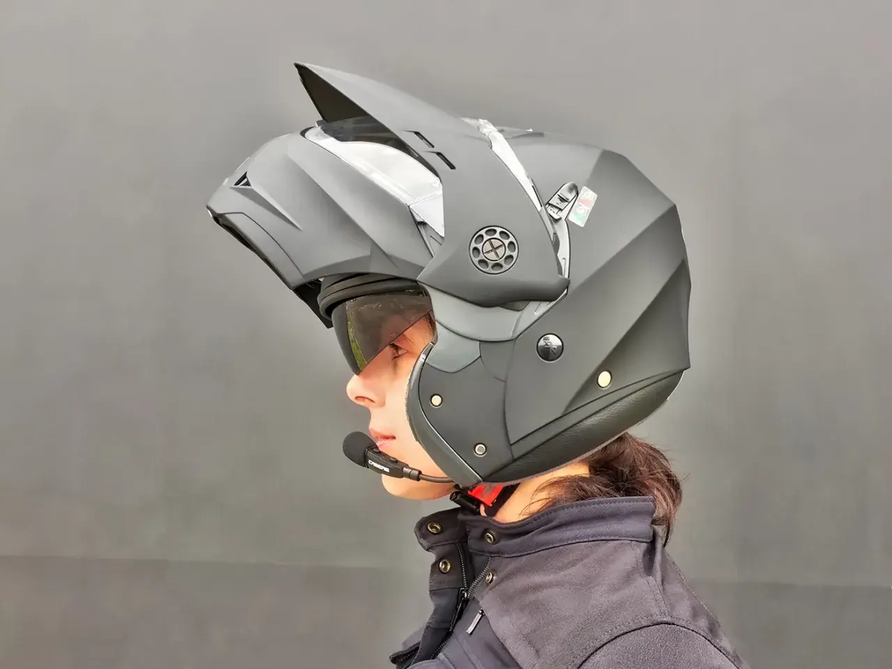 Casco da moto modulare nero, con microfono integrato, ideale per ogni tipo di viaggio. Il materiale è resistente e leggero.